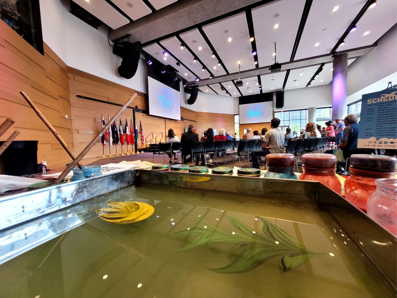 Erdem Balikci presenting ebru art at a large conference or symposium