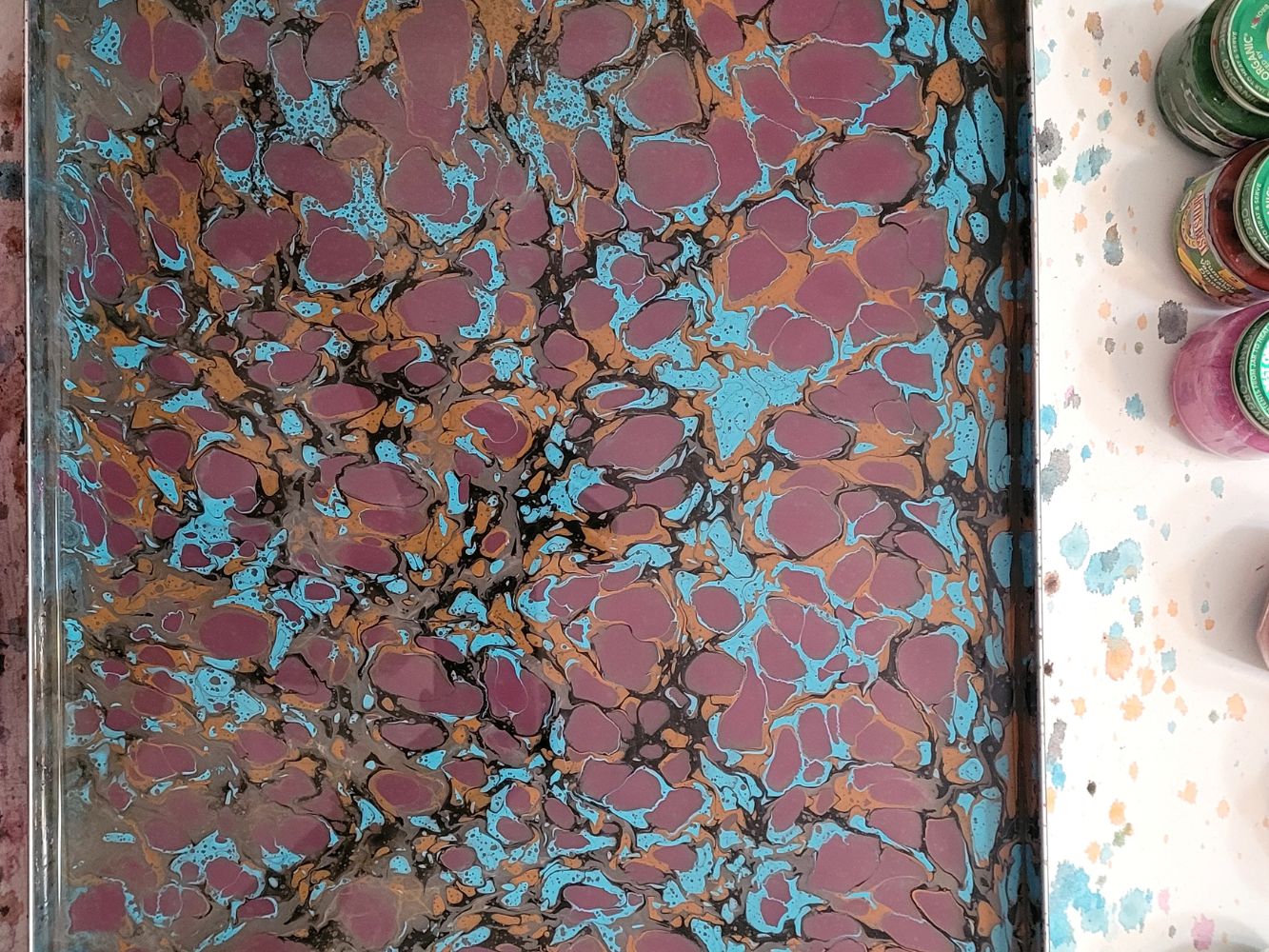 Ebru marbled paper with vibrant blue, teal and purple floral pattern
